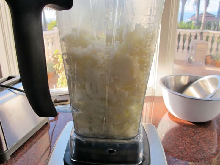 Pureeing cooked cauliflower in a blender.