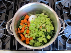 Diced vegetables in a stockpot.