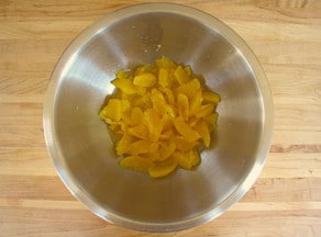 Orange segments in a mixing bowl.