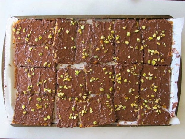 Cutting matzo toffee into squares.