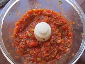 Tomatoes and peppers in a food processor.