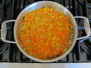 Diced vegetables in a saucepan.