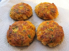 Salmon cakes draining on paper towels.