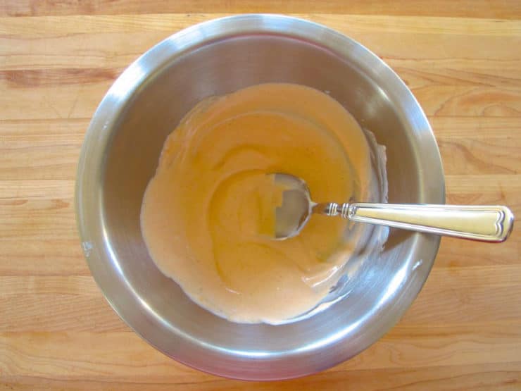 Mixing sriracha sauce in a bowl.
