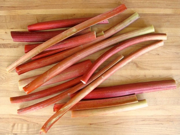 Rinsed rhubarb stalks on a cutting board.