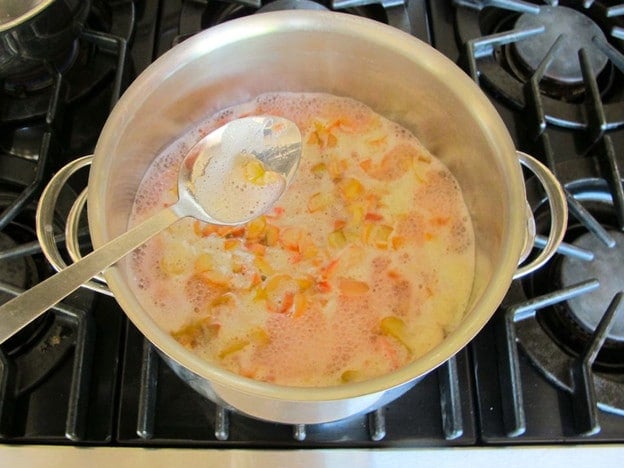 Skimming foam off simmering rhubarb.