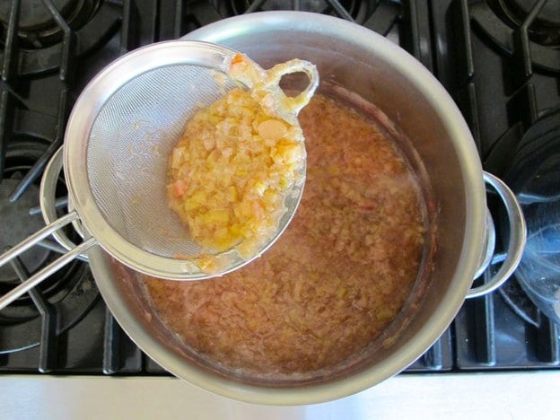 Straining rhubarb from the cooking water.
