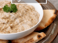 A bowl of creamy Baba Ghanoush surrounded with pita