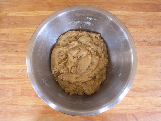 Oil and eggs added to flour in a mixing bowl.