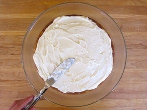 Frosting a round cake layer.