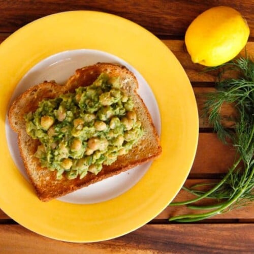 Chickpea and lemon pesto toast topped with lemon-dill chickpea avocado salad