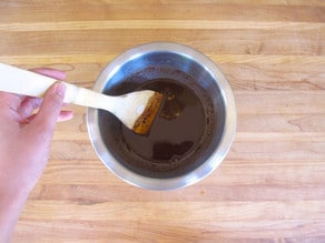 Stirring together chocolate and hot water.