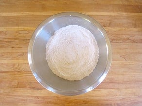 Flour and other dry cake ingredients in a mixing bowl.