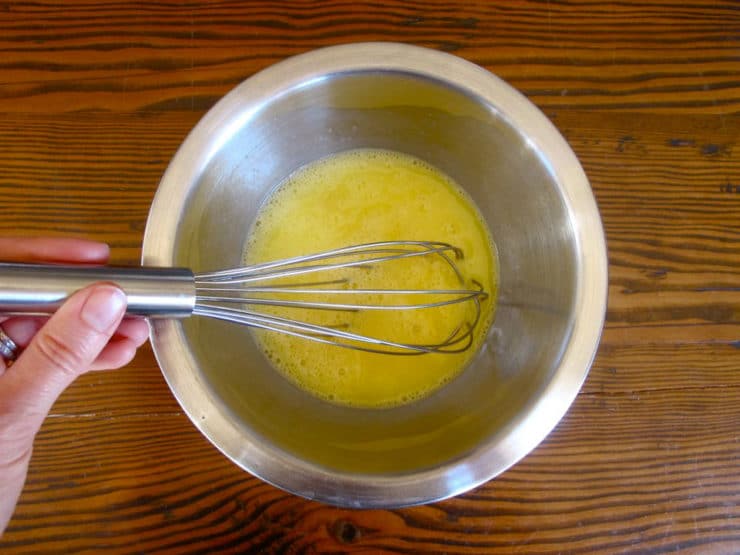 Eggs whisked in a mixing bowl.