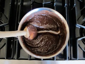 Thickened truffle filling in a saucepan.
