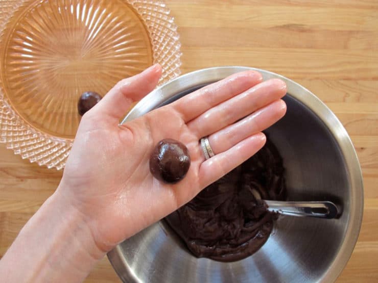 Rolled truffle center in palm of hand.
