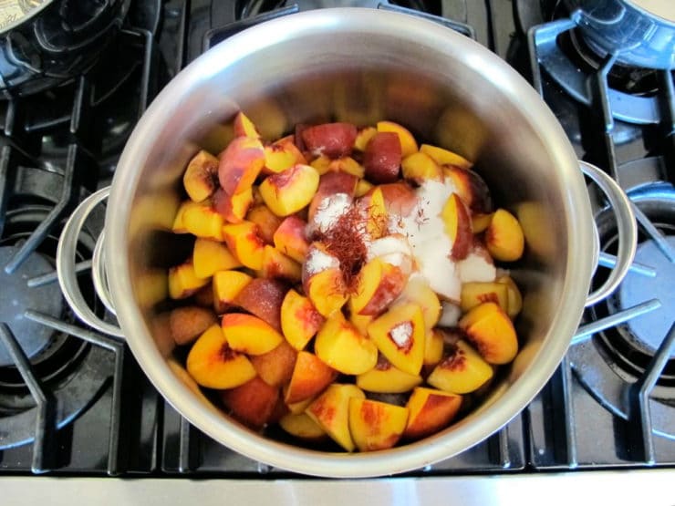 Sliced peaches in a large stockpot.