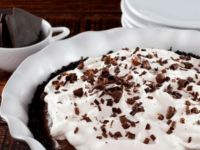 Mocha Pudding Pie adorned with whipped cream and chocolate shavings