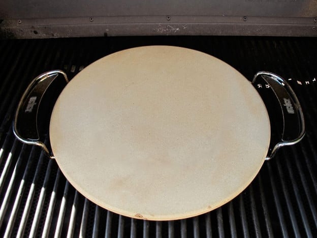 Pizza stone preheating on the grill.