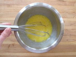 Whisking eggs in a mixing bowl.
