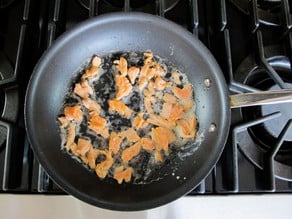 Lox pieces frying in butter.