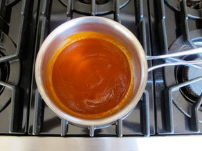 Honey sauce ingredients in a saucepan.