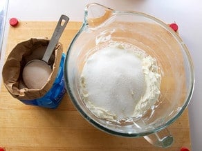 Beating sugar into cream cheese filling.
