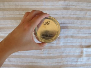 Adding canning rings to jars, finger tight.