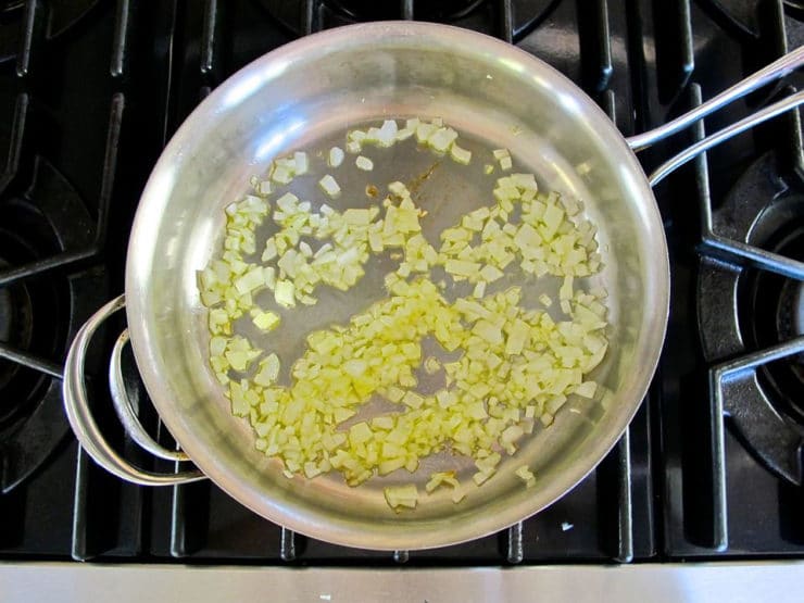 Onion sauteeing in a pan.