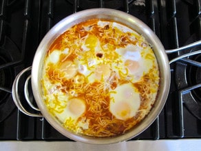 Eggs cooked in tomato sauce in a pan.