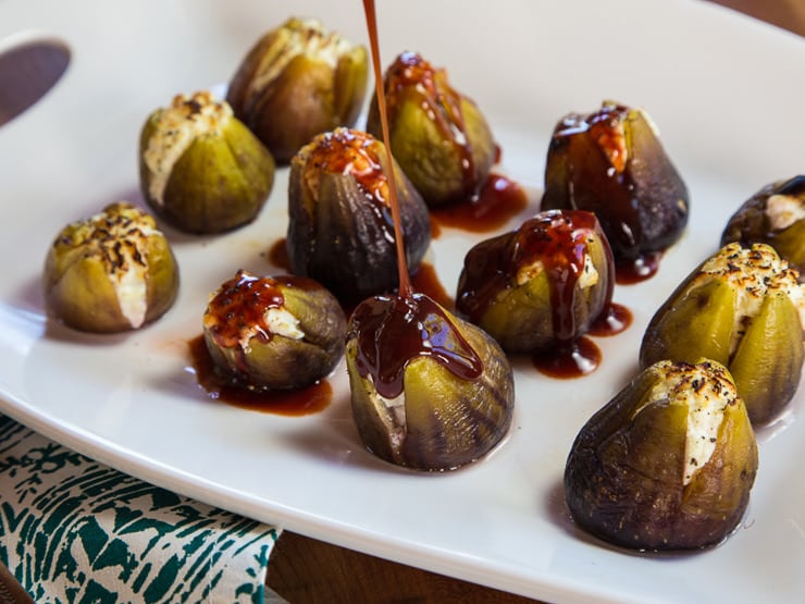 Pouring honey over stuffed figs.