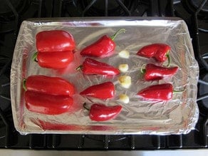 Peppers on a foil lined baking sheet.