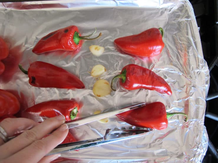 Flipping peppers with tongs.