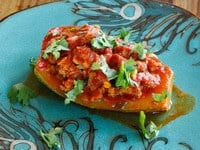 Recipe for Stuffed Zucchini with ground beef or lamb, pine nuts, tomato sauce and spices. Low carb, paleo, grain free.