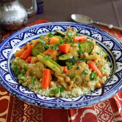 A colorful dish with tender chicken, vibrant vegetables, and fluffy couscous