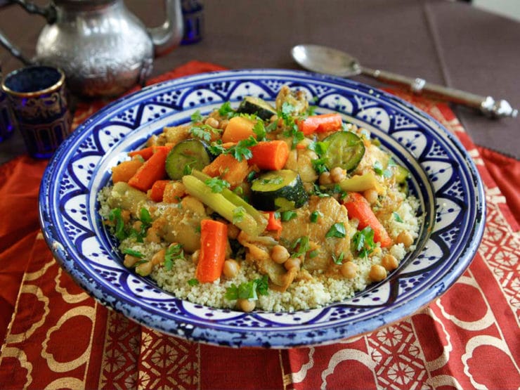 A colorful dish with tender chicken, vibrant vegetables, and fluffy couscous