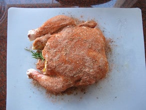 Spices rubbed into chicken.