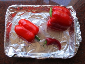 Peppers on a foil-lined baking sheet.