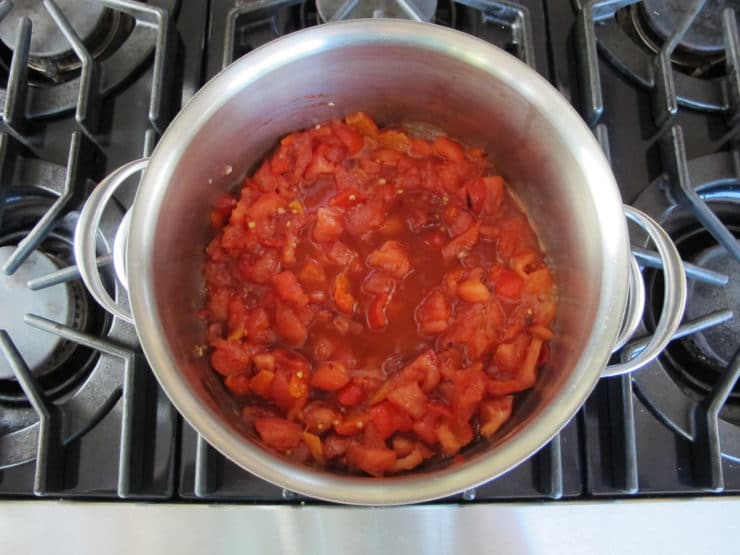 Peppers and tomatoes in a stock pot.