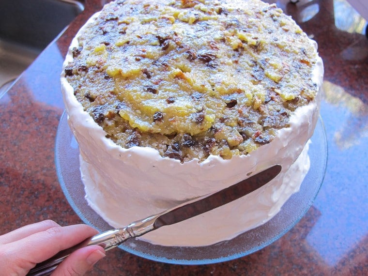 Frosting the sides of a cake.