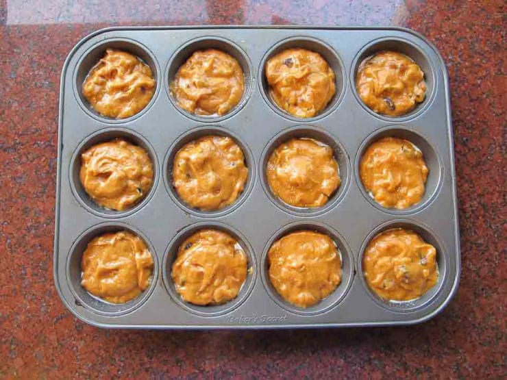 Pumpkin cupcake batter in a cupcake tin.