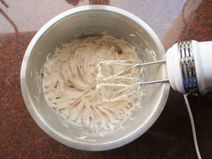 Beating frosting with electric mixer.