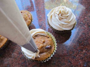 Frosting cupcakes with a star tip.