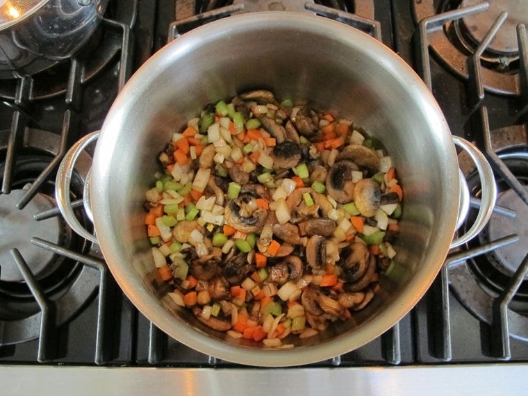 Carrots and celery added to pot with mushrooms.