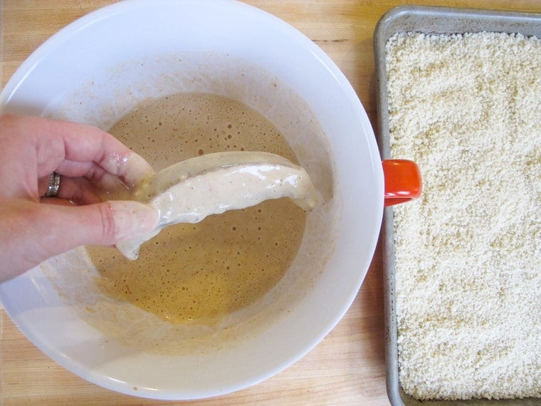 Dipping mushroom slices into batter.