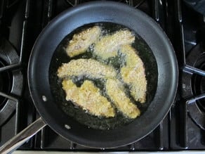 Frying portobello slices in a pan.