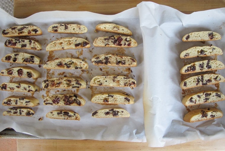 Lined and arranged cut Dark Chocolate Cherry Mandelbrot on a baking sheet