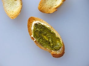 Pesto spread on toasted baguette.