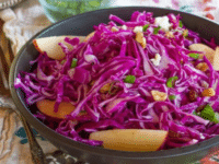 Colorful salad with red cabbage, apples, and walnuts