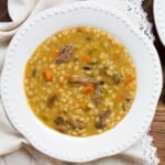 A comforting dish featuring beef flanken, mushrooms, and barley in a flavorful broth